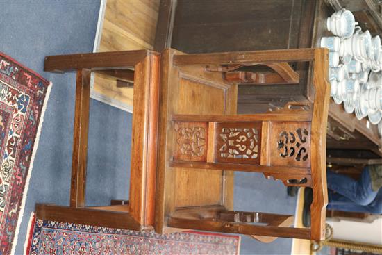 A pair of Chinese carved hardwood elbow chairs